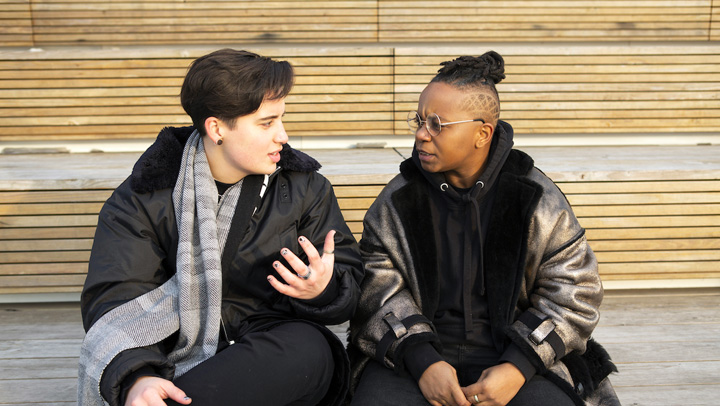 Two members of the BIPOC and LGBTQ communities sitting in discussion