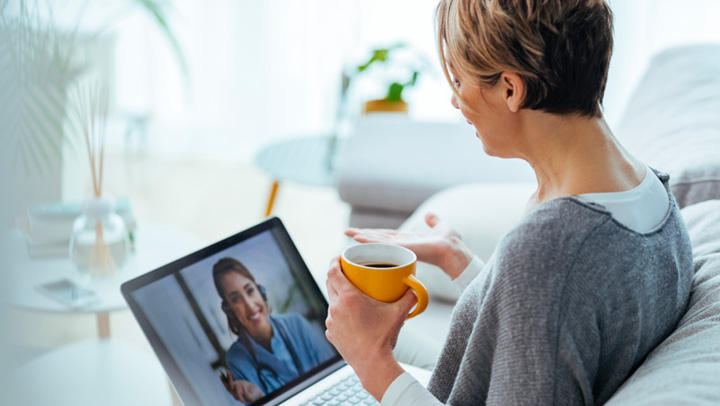 Two women participate in a telehealth session for people affected by addiction
