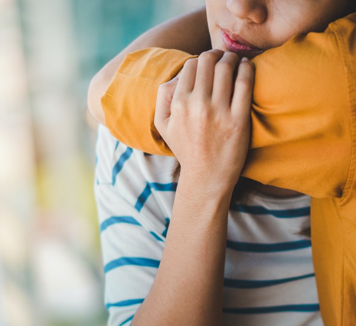 Person hugs their loved one affected by addiction and a mental health disorder