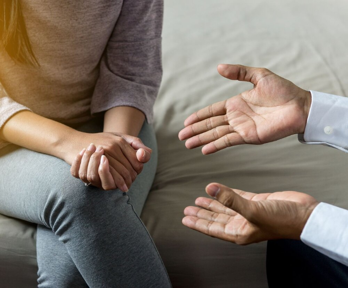 Two people in a one-on-one therapy session for individuals affected by addiction