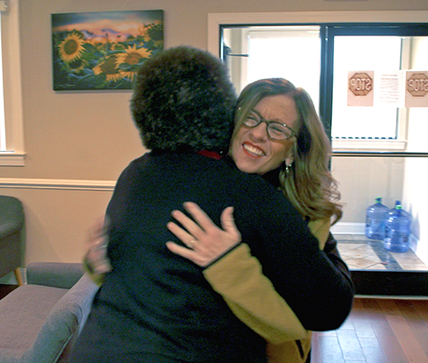 Eleanor health member and community recovery partner embracing and smiling