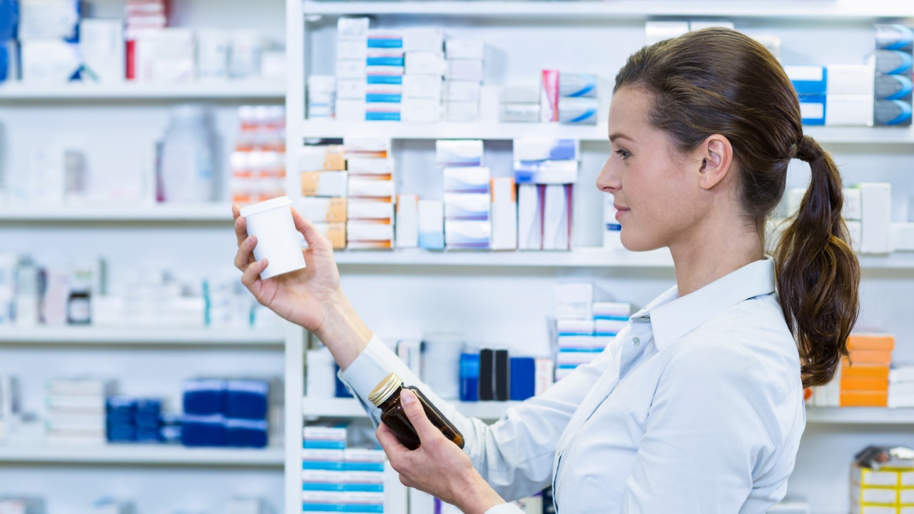 Pharmacist looking at medications for medication-assisted addiction treatment