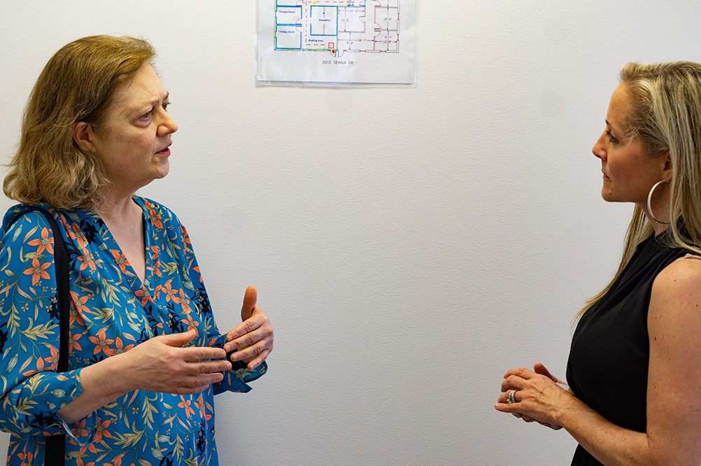 Danica Patterson, Operations Manager for North Carolina, talks to a woman during an open house at Eleanor Health Matthews Clinic