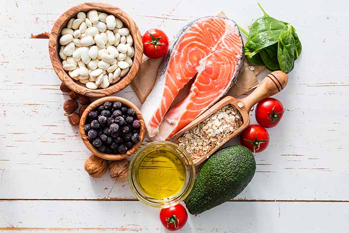 A variety of healthy foods placed on a table in the shape of a heart