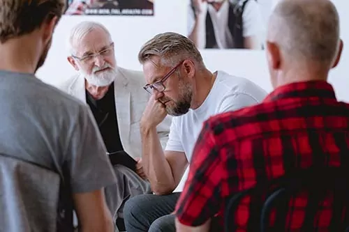 A group of veterans discuss their alcohol use during a group session