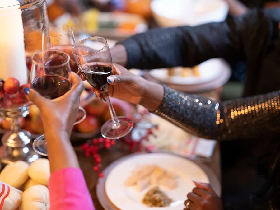 a family toasting with wine glasses at a holiday meal