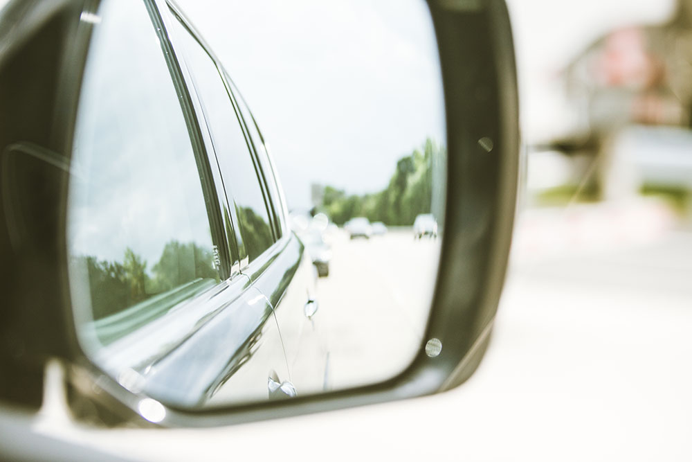 The view of a car in a side view mirror