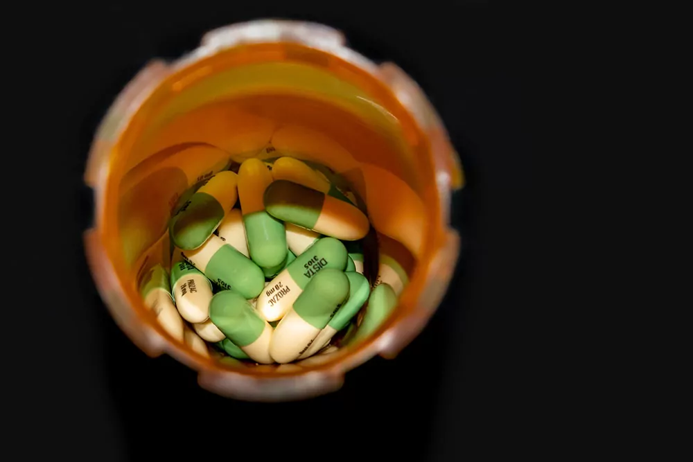 A pill bottles filled with Prozac or Fluoxetine capsules for anxiety or depression treatment