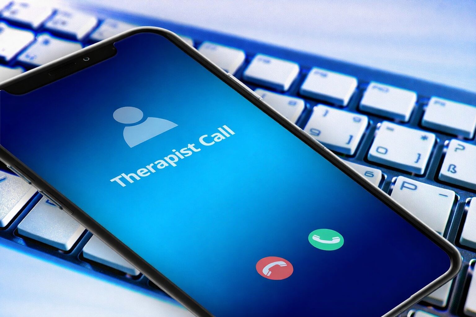 An image of a smartphone showing an incoming call from a person's therapist for virtual outpatient rehab.